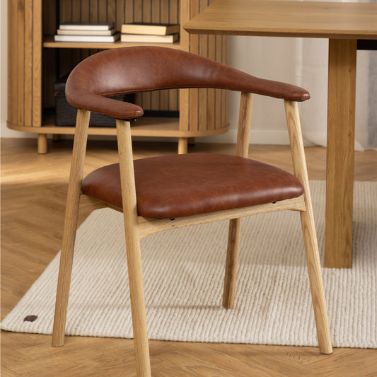 Stylish dining chair with a curved backrest and seat upholstered in rich brown leather, supported by a light oak wooden frame