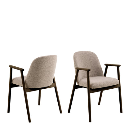 Modern dining chair with a beige upholstered seat and backrest, featuring a sleek dark wooden frame and angled legs. The chair has minimalist wooden armrests integrated into the frame.