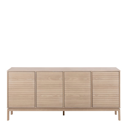 Modern light wood sideboard with four slatted doors and raised legs in Scandinavian design.