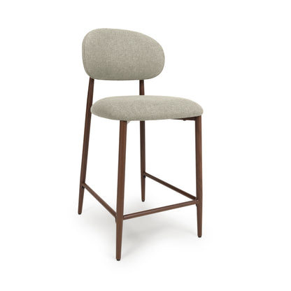 A modern counter chairs with a light beige textured fabric upholstered seat and curved backrest, supported by a dark brown metal frame with leg extensions and footrests