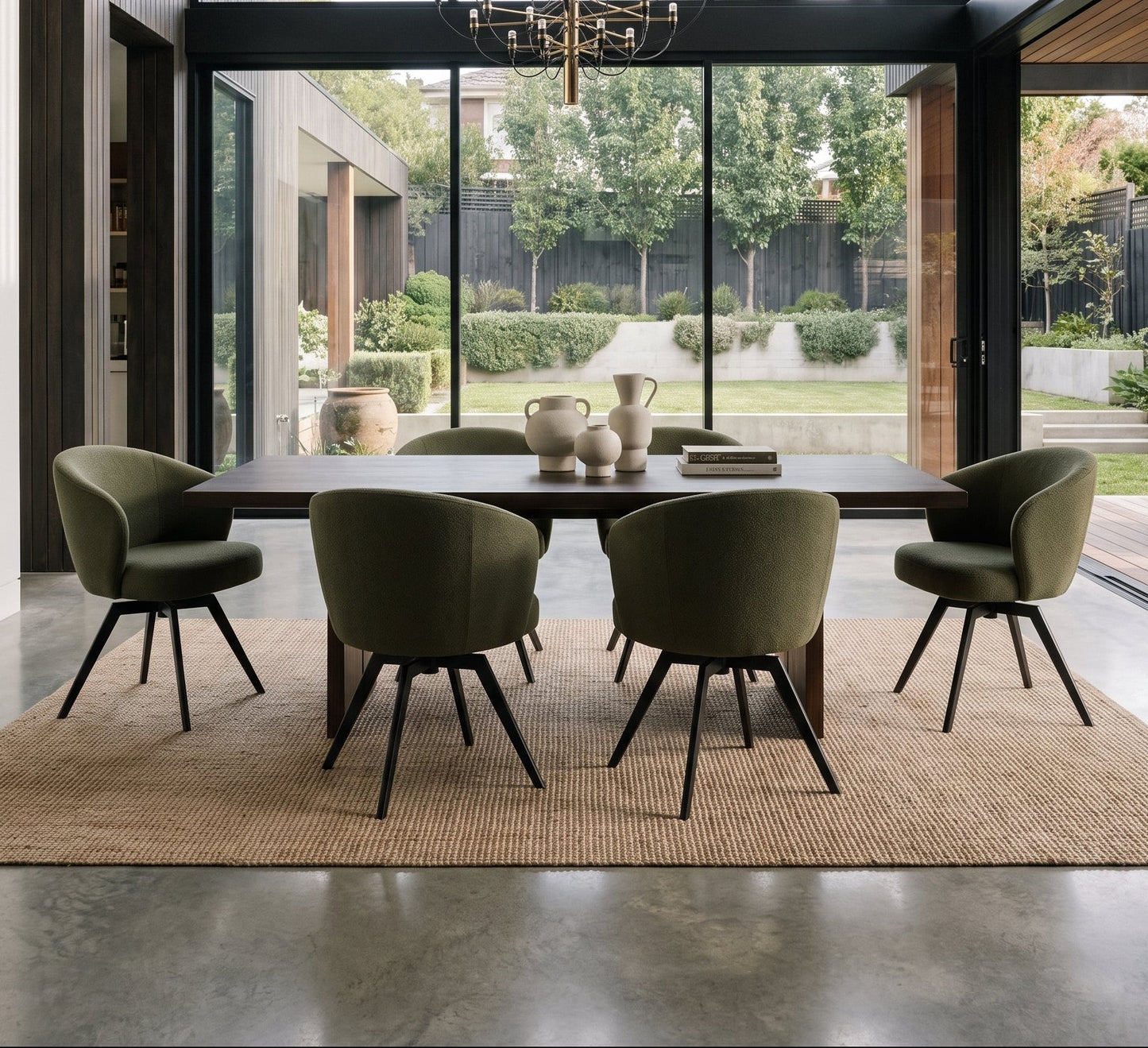 Modern dining room with olive green swivel chairs, a wooden table, and floor-to-ceiling windows overlooking a garden.