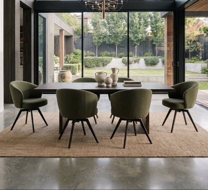 Modern dining room with olive green swivel chairs, a wooden table, and floor-to-ceiling windows overlooking a garden.