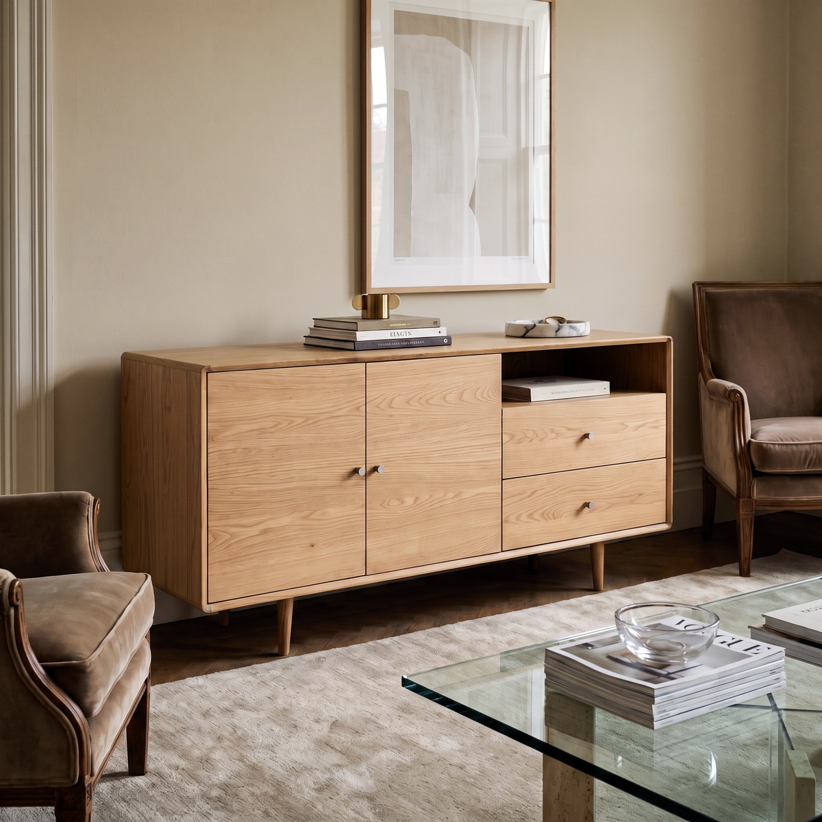 Rowan Large Oak Sideboard styled in a minimalist living room with a neutral rug, velvet armchairs, and a glass coffee table.